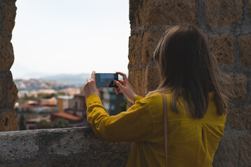 Wall Mural - Girl shoots beautiful views of Naples on the phone.