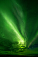 Aurora Borealis, Bands Of Bright Green Light Flashing Across The Night Sky Over The Horizon; Iceland