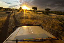 A Rifle On Top Of A Safari Vehicle Heading Into The Bright Sun.