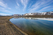 © Designpics - Clouds and tundra pond of melt runoff in summer.