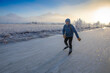 © Designpics - Man backcountry ice skating on Rabbit Slough with frosty fog and bright sun in winter, Alaska, USA