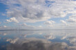 © Designpics - Clouds and sky are reflected in calm water with bridge; Tampa Bay, Florida