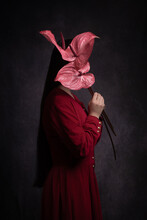 Abstract Dark Portrait Of A Woman In A Red Dress Holding Pink Anthurium Flowers Hiding Her Face