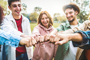 Wall Mural - Multiracial group of young people making fist bump as symbol of unity, community and solidarity - Teamwork join hands and support together