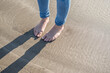 © Designpics - Detail of a young woman's feet on the beach at Porthmadog.