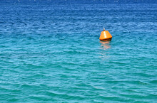 Orange Buoy Floating On The Sea As A Warning To Ships. No People. Copy Space.