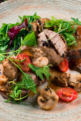 Canvas Print - Restaurant menu veal medallions with mushrooms, arugula, cherry tomatoes and sauce, closeup.