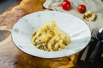 Poster - Fettuccine with chicken and mushrooms and parmesan on wooden table