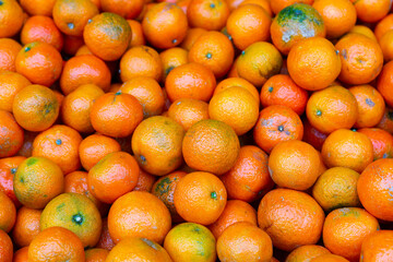 Wall Mural - Fresh ripe mandarins on the counter in supermarket, puts out for sale. Close-up image