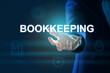 © New Africa - Bookkeeping concept. Businessman holding word on dark blue background with digital icons, closeup