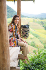 Poster - Asian female tourist sitting on the patio enjoying the natural view of Rice terraces in Chiang Mai Province