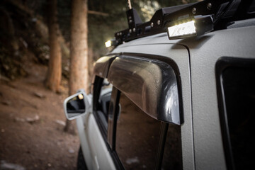 Wall Mural - Close up of custom LED side light bar on roof rack off road car.