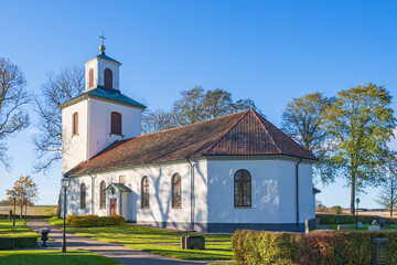 Wall Mural - Countryside church with a cemetery