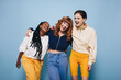 © Jacob Lund - Group of young, diverse Gen Z women laugh and enjoy themselves in a vibrant studio setting, celebrating their friendship and good times