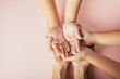 Close up hands children on adult mother hand, Top view person kid stack mom palms, Parents and little kid holding empty hands together isolated on pink background, Family day care concept