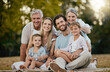 © Delcio F/peopleimages.com - Family picnic, park portrait and smile with kids, parents or grandparents for bonding together, love or relax. Happy family, nature and generation care with children, mom and dad in summer sunshine
