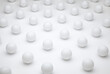 Pattern of white round ping pong balls on a white background representing monotony, uniformity, similarity, traditional values, order, unimaginative and repetitive thinking, or purity and freshness