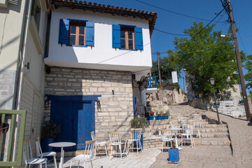 Wall Mural - Traditional Greek restaurant with blue and white walls and window shutters in a Greek Village