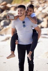 Wall Mural - Couple, piggyback and selfie on the beach to have fun and bond with love and affection. Man, woman and ocean date while taking a mobile photo on the sea sand for romance and tropical holiday