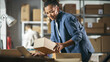 © Gorodenkoff - Inventory Manager Preparing a Small Cardboard Parcel for Postage. Multiethnic African American Female Small Business Owner Working on Laptop Computer in Warehouse