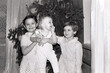 © Olga - old scanned black and white photo from the family archive, families near the Christmas tree