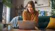 © Gorodenkoff - Portrait of Smiling Young Woman Working from Home on Laptop Computer in Sunny Cozy Apartment. Successful Creative Girl Entrepreneur Does Remote for e-Business Project, Online Shopping
