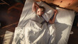 © Gorodenkoff - Top View Home: Handsome Young Man Sleeps in His Bed, Sun Shines on Him, He Opens Eyes and Greets New Sunny Day at Home. Joyful Waking Up of a Guy who is Ready for Productive Day. Top Down Above Shot