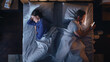 © Gorodenkoff - Top View Bedroom Apartment: Young Woman Uses Smartphone in Bed at Night When Her Male Partner Trying to Fall Asleep Beside. Couple Fight, Argue. Social Media, Doom Scrolling, Fake News Addiction