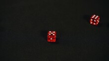 Casino Player Rolls Eleven In Craps, Rolling Five And Six With Pair Of Red Dice On Black Background, Slow Motion