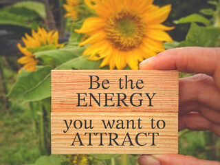 Be the energy you want to attract. Text on wooden blocks with nature background. Inspirational and motivational Concept.