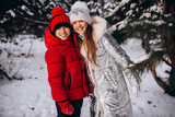 Fototapeta Las - Happy Brother and sister. Portrait in winter time in forest
