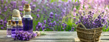 Fototapeta  - Essential oil bottle and lavender flowers field