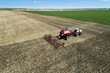 © Designpics - Tractor pulling an air seeder, seeding a field with blue sky in the distance, West of High River; Alberta, Canada