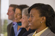 © Designpics - Team of business people with three business women and one business man standing in a row