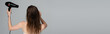© LIGHTFIELD STUDIOS - back view of young woman with wet hair using hair dryer isolated on grey, banner