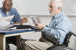 © Designpics - Professor with Muscular Dystrophy in a wheelchair at a college faculty meeting