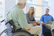 © Designpics - Man with Muscular Dystrophy in a wheelchair talking with friends