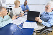 © Designpics - Professors in a faculty meeting, one in a wheelchair with Muscular Dystrophy