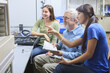 © Designpics - Professor working with students in a chemistry lab learning about instrumentation (PH Meter)