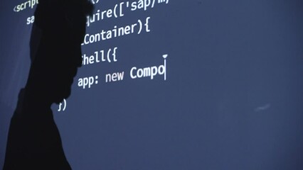 Silhouette of programmer coding. Man coding html and programming .Web developer concept
