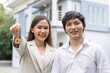 New home owner happy family asian young couple love, wife hug husband, showing house key. Banker agreement mortgage loan purchase buy, property lease real estate for relocation after married.