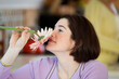 © Designpics - A woman smelling a daisy.