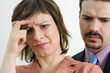 © Designpics - Close-up of a businesswoman suffering from a headache with a businessman behind her