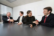 © Designpics - Business colleagues shaking hands in a boardroom.