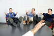 © Designpics - Businessmen gesturing with feet on desk.