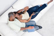 © Designpics - High angle view of a middle-aged couple romancing on a couch