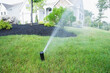 © Designpics - Water being sprayed from a sprinkler in a lawn