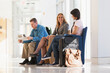 © Designpics - Three passengers waiting in an airport lounge