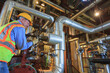 © Designpics - Engineer in electric power plant adjusting condenser piping valve