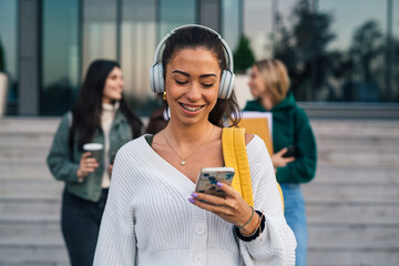 Wall Mural - Front view of a college student with braces and headphones